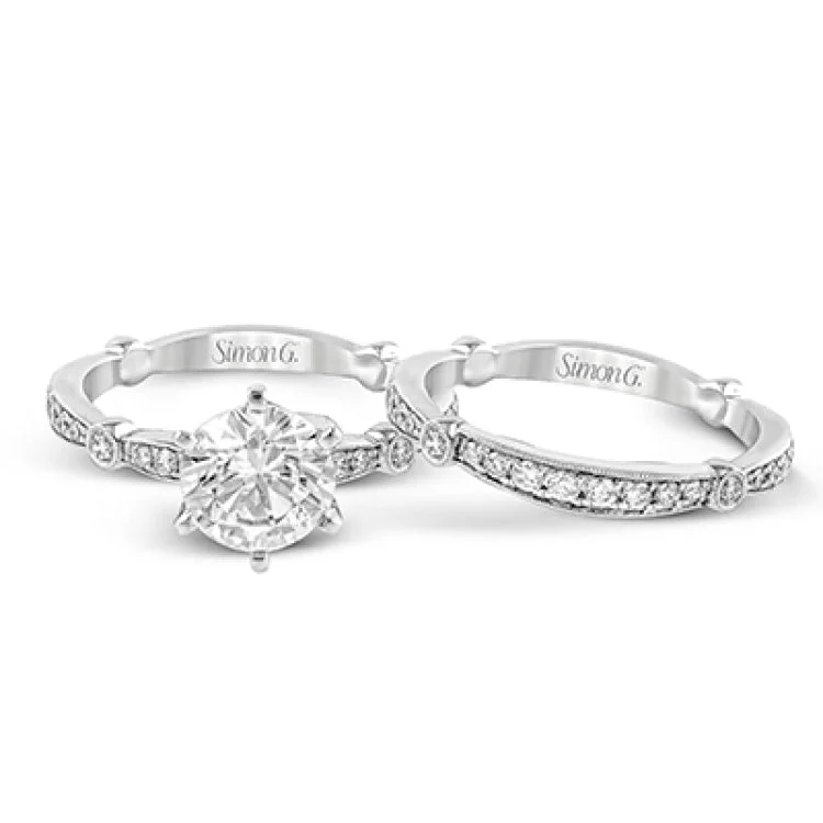 Women’s elegant engagement rings-Featuring a dazzling contemporary design, this elegant white gold engagement ring and wedding band set is accented by .59 ctw of round cut white diamonds.