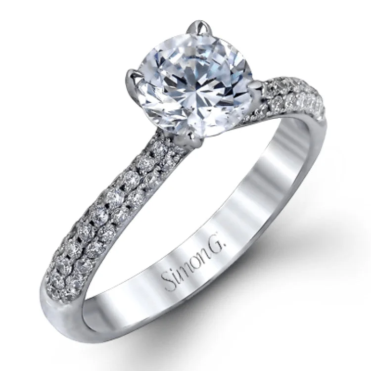 Women’s halo engagement rings-The classic design of this white gold engagement ring and wedding band set is emphasized by .72 ctw round cut white diamonds.