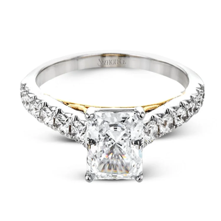 Women’s diamond engagement rings for proposal-A touch of 18k yellow gold filigree on the interior of this ring adds a special touch to this 18k white gold engagement ring made for an emerald shape center stone.