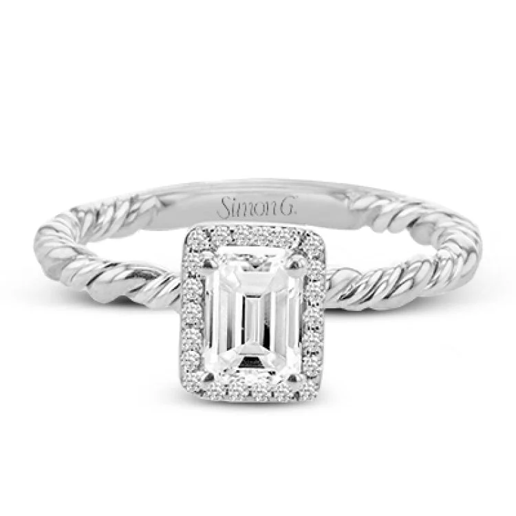 Women’s halo diamond engagement ring sets-This halo engagement ring employs a twist of yellow and white gold together, and is made for an emerald shape center stone.