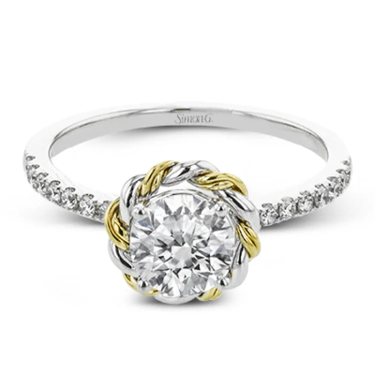 Women’s split shank engagement rings-This distinctive engagement ring features .40 ctw of white diamonds on the shank of the ring and a halo made from a twisted design of yellow and white gold.