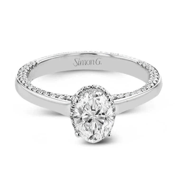 Women’s platinum engagement rings-This engagement ring is made from an oval center stone and features a low halo as well as diamonds extended down the sides of the ring.