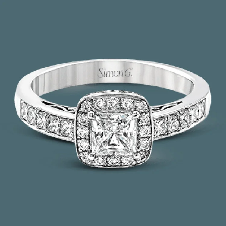 Women’s luxury wedding and engagement rings-This lovely contemporary white gold engagement ring is set with .34 ctw of glistening princess cut white diamonds and .13 ctw of round cut white diamonds.