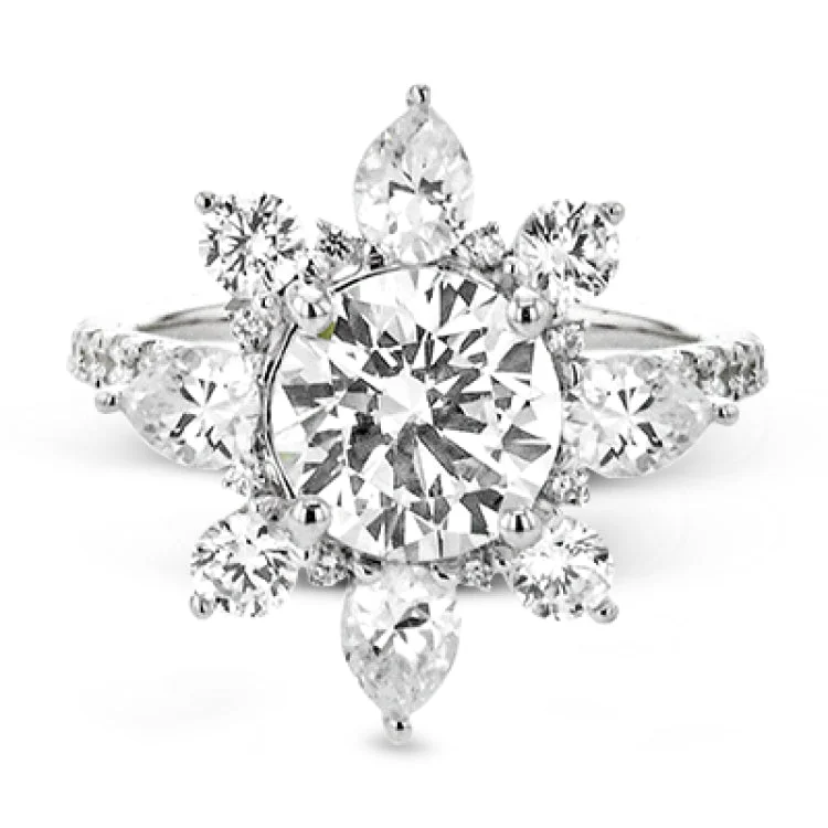 Women’s unique engagement rings-Pear shaped diamonds are set into a pointed halo that expands outward like a cosmic explosion in this Supernova Collection engagement ring.