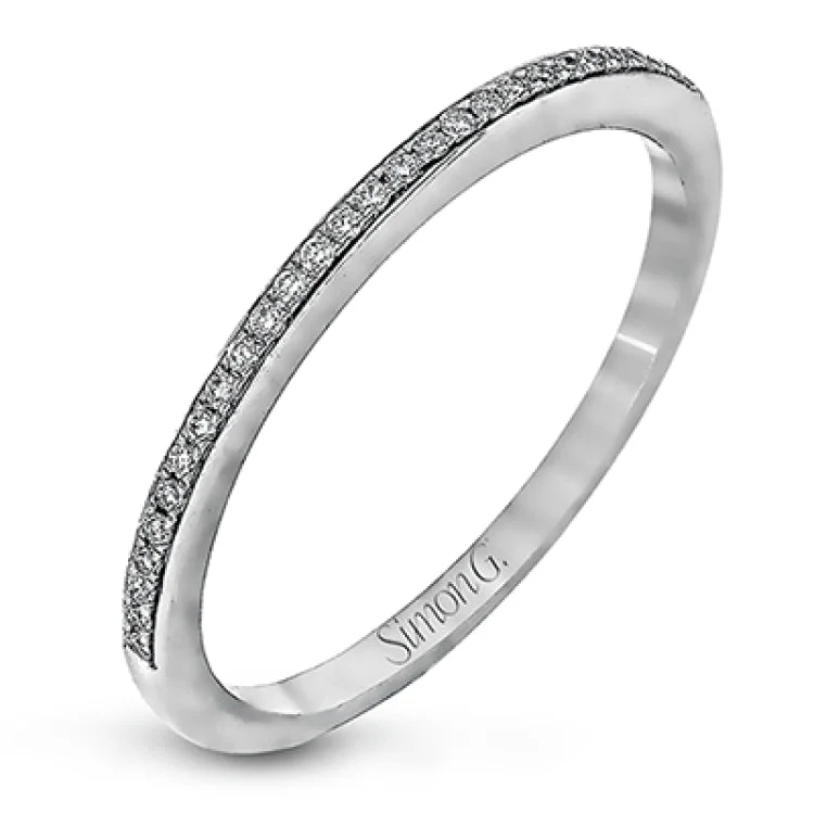 Women’s three-stone engagement rings-The elegant design of this classic white gold engagement ring and wedding band is complemented by .21 ctw of glimmering round cut white diamonds.