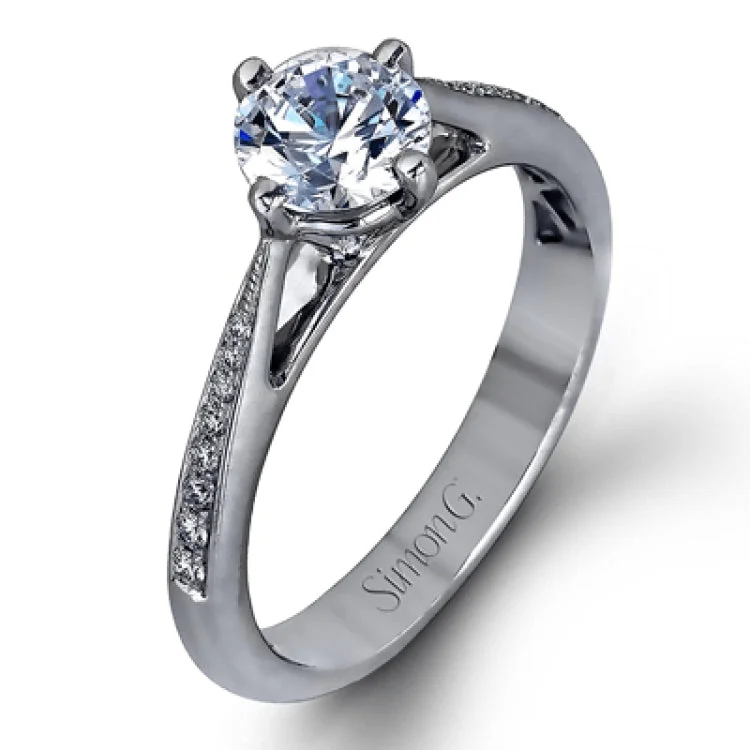 Women’s wedding engagement rings-The elegant design of this classic white gold engagement ring and wedding band is complemented by .21 ctw of glimmering round cut white diamonds.