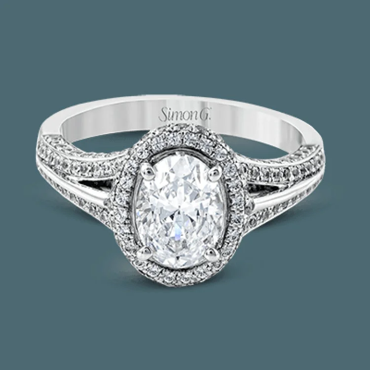 Women’s gold engagement rings with diamonds-This lovely 18k white gold engagement ring design is created for an elegant oval center stone and features .77 ctw of white diamonds accented by a small touch of .03 ctw of yellow diamonds.