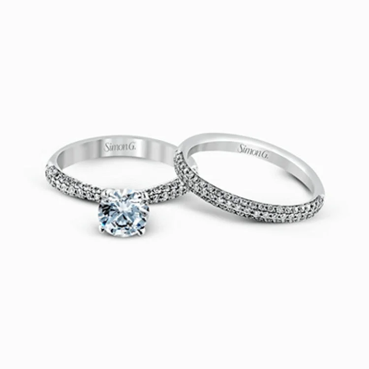 Women’s personalized engagement rings-The classic design of this white gold engagement ring and wedding band set is emphasized by .72 ctw round cut white diamonds.