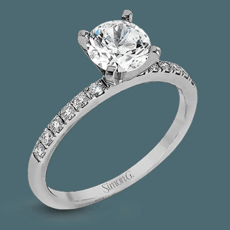 Women’s vintage inspired engagement rings-Featuring a modern take on a classic design, this white gold engagement ring and wedding band are inset with .58 ctw of glimmering round cut white diamonds.