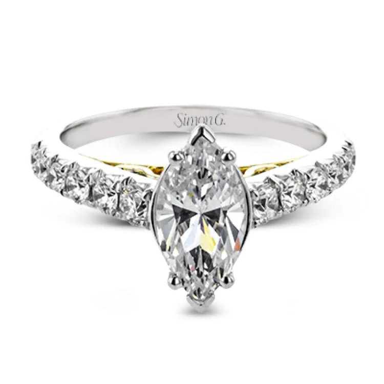 Women’s elegant engagement rings-A touch of 18k yellow gold filigree on the interior of this ring adds a special touch to this 18k white gold engagement ring made for a marquise shape center stone.