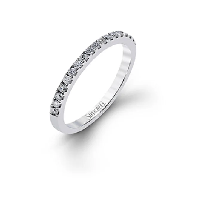 Women’s silver engagement rings-This playful white gold wedding set features .92 ctw of round white diamonds and an exaggerated halo for a subtle floral-inspired design.