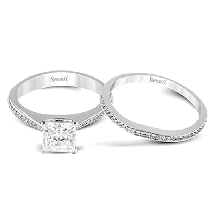 Women’s cushion cut diamond engagement rings-Featuring a simple, elegant classic design, this white gold engagement ring and wedding band is set with .16 ctw of round cut white diamonds.