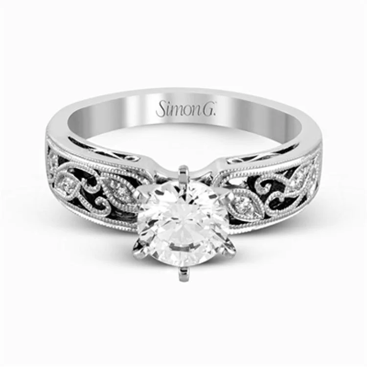 Women’s solitaire diamond engagement rings-This intricately designed white gold engagement ring features .07 ctw of exquisite round cut white diamonds, setting the stage for a stunning center stone.