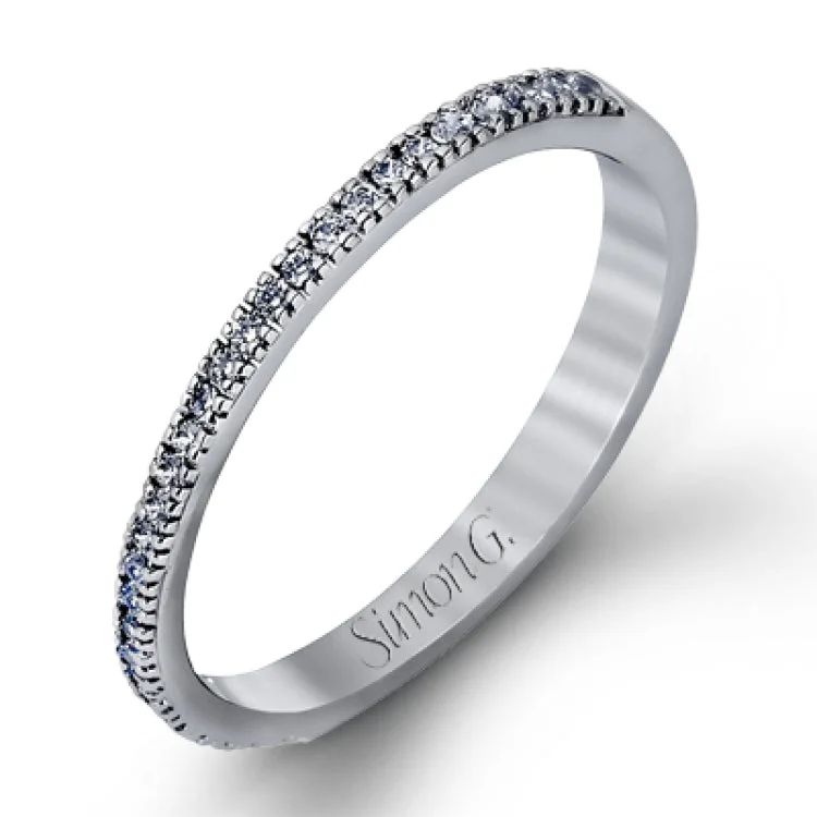 Women’s heart-shaped engagement rings-Accented by .46 ctw of glistening round cut white diamonds, this contemporary white gold halo style engagement ring and wedding band set makes a dramatic statement.