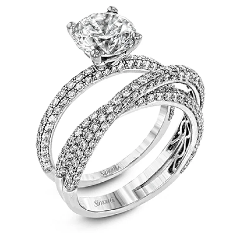 Women’s engagement rings with a romantic touch-Presenting an eye-catching modern design, this white gold engagement ring and wedding band are highlighted by 1.45 ctw of round cut white diamonds.