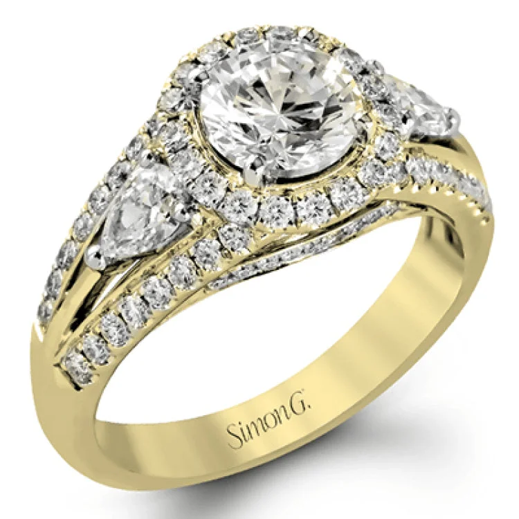 Women’s round diamond engagement rings-The elegant design of this classic white gold engagement ring is set with .62 ctw of round cut white diamonds and .40 ctw pear shaped white diamonds.