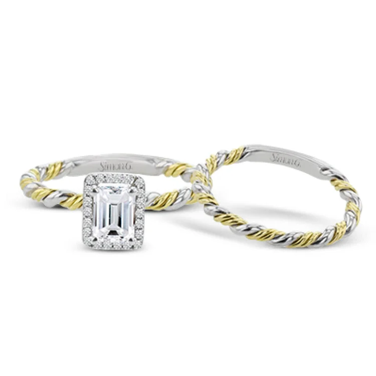 Women’s engagement rings with a royal touch-This halo engagement ring employs a twist of yellow and white gold together, and is made for an emerald shape center stone.