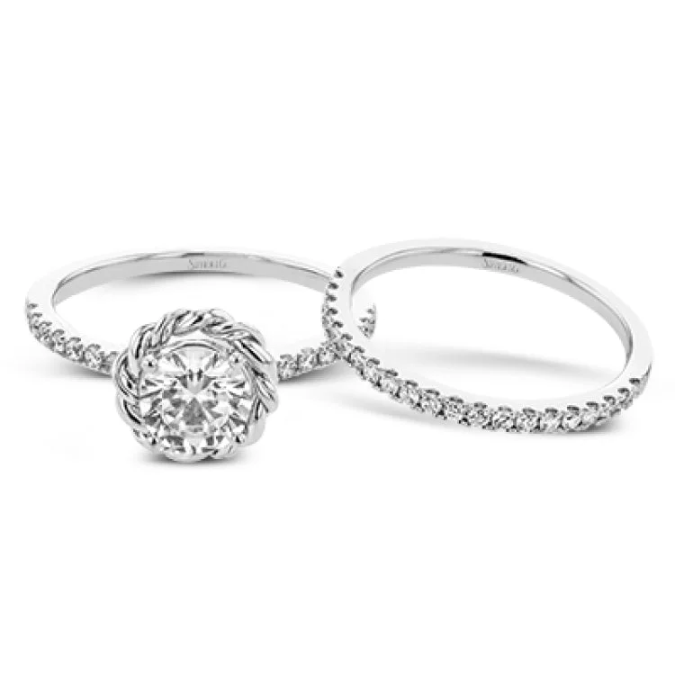 Women’s engagement rings with side stones-This distinctive engagement ring features .40 ctw of white diamonds on the shank of the ring and a halo made from a twisted design of yellow and white gold.